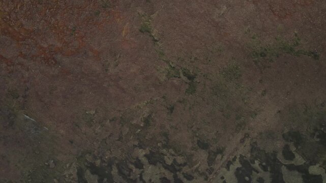 Top down drone view captures rugged terrain and abstract natural patterns across remote landscape, showcasing texture, geology and environment in Morocco