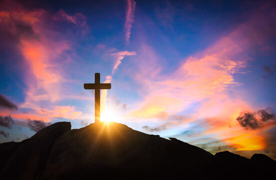 Cross silhouette on sunset sky background. Christian religion concept. 