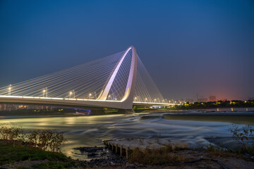Fototapeta premium Night view of Shougang Bridge, a modern bridge landmark in Beijing, China.
