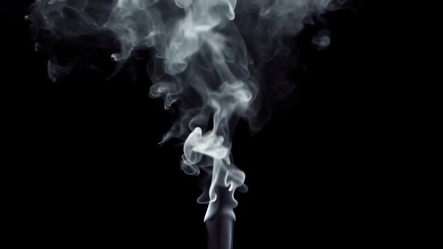 Wisps of white smoke elegantly rising and swirling against a stark black background in a dramatic abstract display