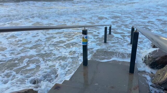Climate change impact is evident as stormy seas and powerful waves crash against the coastline in Adelaide, Australia. This footage captures the destructive force of nature