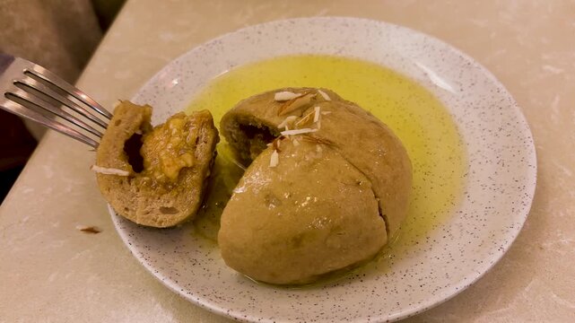 traditional himachali siddu served with ghee and almond garnish in authentic style