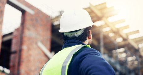 Fototapeta premium Construction, thinking or man outdoor with inspection, progress reflection or mindset in building review. Industrial, low angle or engineer with back, project assessment or operation insight on site.