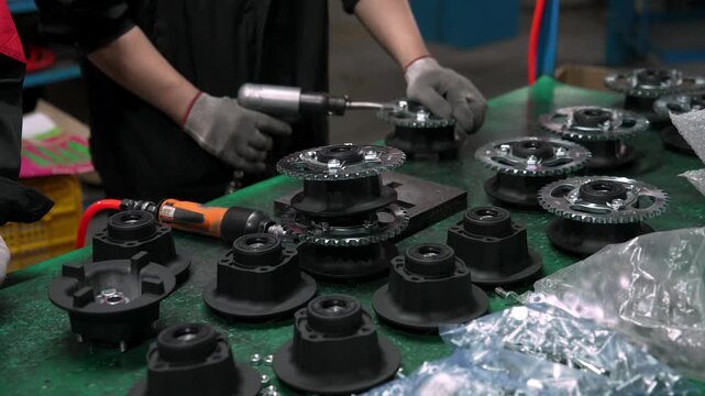 Asian Factory Worker Installs Component during Engine Assembly Process. Professional Technical Specialist Uses Hand Tools on Chinese Manufacturing Line. Industrial Equipment Needs Precision 4k