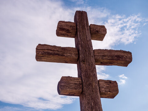 Traditional wooden patriarchal cross against a blue sky, symbolizing Christian faith, spirituality, Saints Cyril and Methodius, cultural heritage and Slovak identity.