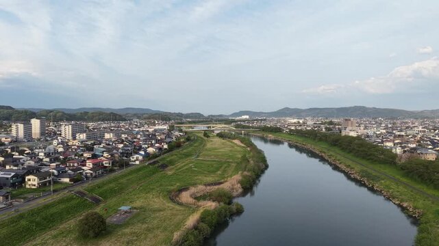 SHIBATA, JAPAN.Riverside sakura landscape April 28 2026