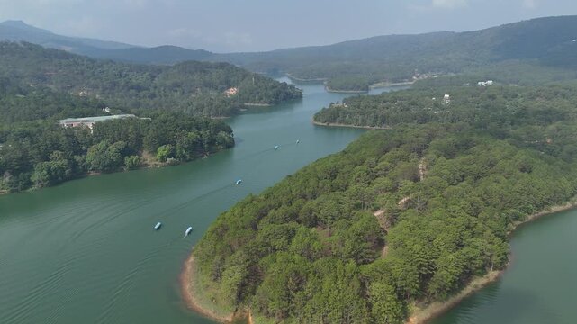 Aerial View of Tourist Boats Cruising on Tuyen Lam Lake in Misty Da Lat, Vietnam