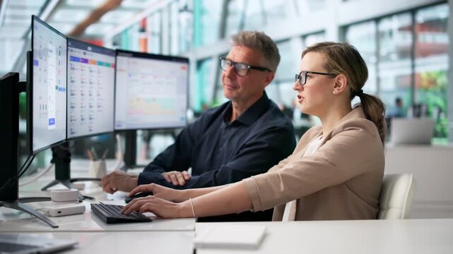 Payroll Manager And HR Specialist Reviewing Employee Salary Automation System