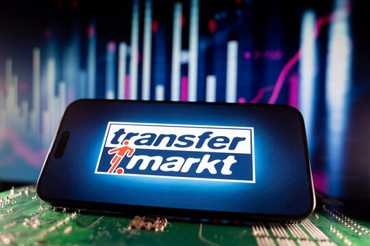 Close up of Transfermarkt logo on smartphone screen with financial chart background. Toronto, Canada - June 11, 2026.