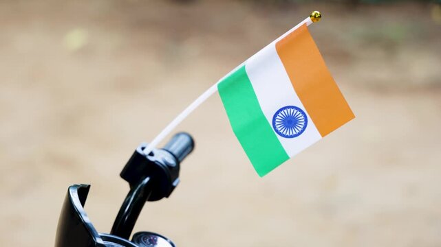 indian national flag mounted on kid motorcycle handlebar with patriotic pride and tricolor symbol