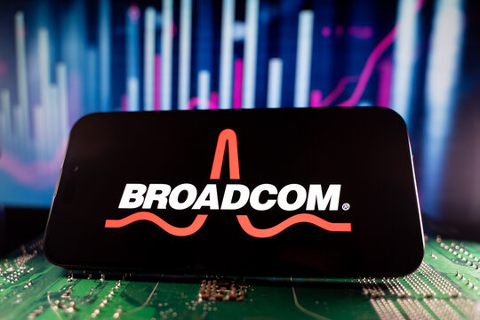 Close up of Broadcom logo on smartphone screen with technology and financial chart background. Toronto, Canada - June 11, 2026.