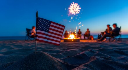 Labor Day Group of friends enjoying a beach bonfire at night with American flag in the foreground and fireworks in the sky