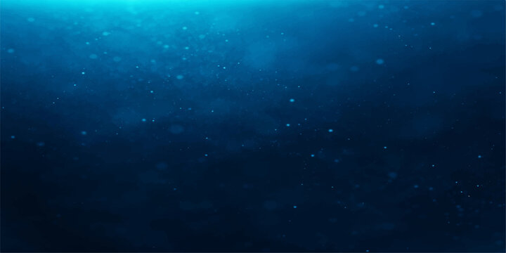 Deep blue ocean water with tiny bubbles rising towards the surface, creating a serene and mysterious underwater ambiance.