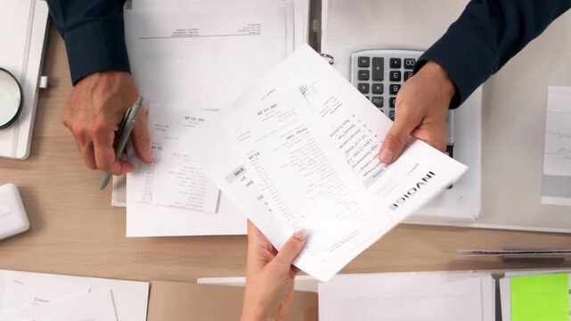 Business Advisor Carefully Reviews Invoices