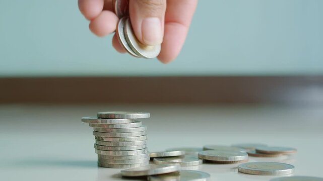 oman holding coin baht, stack money growth pile, concept for business finane investment income or cost tax, loan home, deposit hund future.