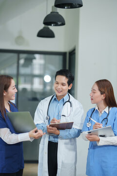 Team of Professional Asian Doctors and Medical Staff Collaborating in Hospital Office