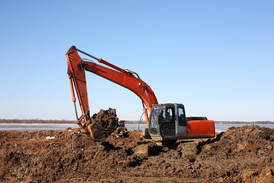Construction - Closeup Orange Excavator work in dirt