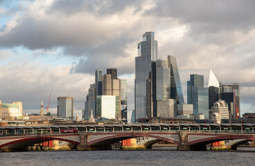 Fototapeta premium London city skyline modern skyscrapers of the city of london financial district and blackfriars bridge over the river thames. Cityscape United Kingdom at sunset