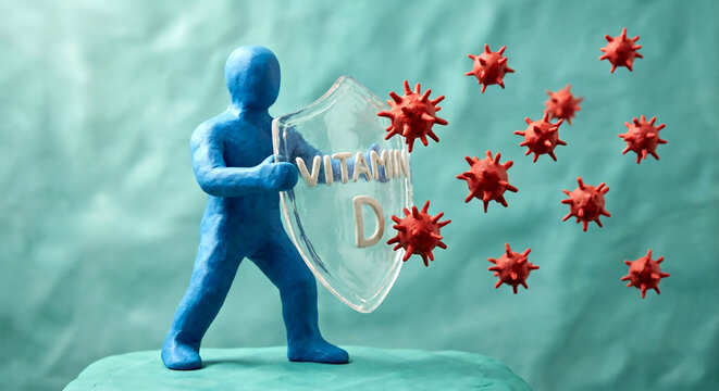 A blue clay figure holds a "Vitamin D" shield to block incoming red, spiky virus cells, representing immune system defense.