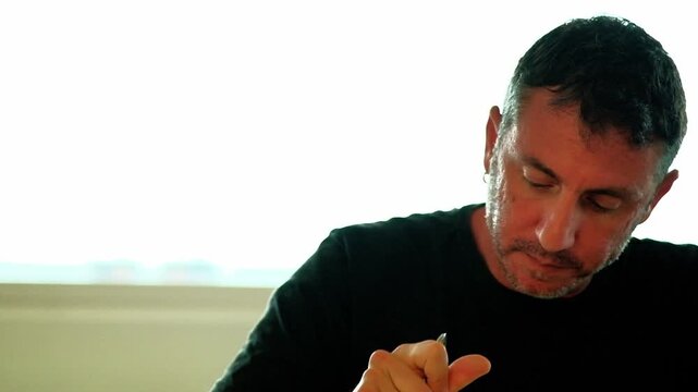 A man eats a type of Italian pasta called "penne". The man is forty-two years old and of Caucasian origin