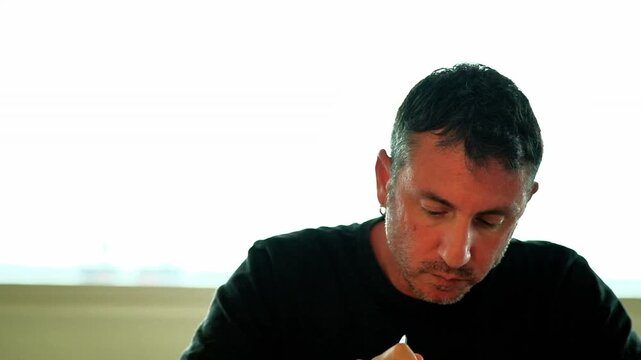 A man eats a type of Italian pasta called "penne". The man is forty-two years old and of Caucasian origin