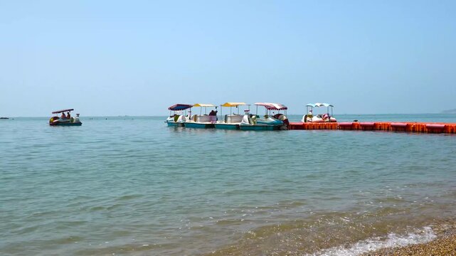 Pedal Boats by a Calm Beach Pier