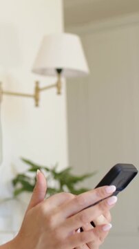 Vertical video: Adjusting ringed hands tapping, swiping phone, checking texts in corner, copy space
