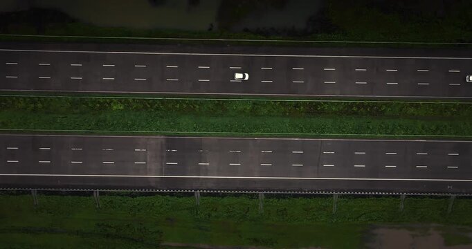Aerial view of the Mumbai-Nagpur Expressway, also known as Samruddhi Mahamarg, captured during the monsoon season. The modern highway stretches through lush green landscapes and rain-soaked fields.