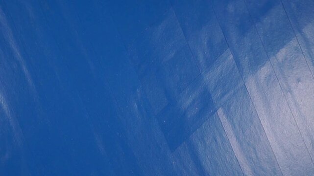 Rotation of striped blue electrical tape surface. Close-up, topview