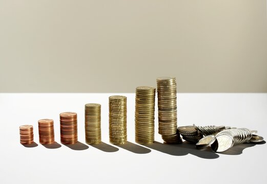 Coin stacks as a bar chart with fallen euros showing financial crisis