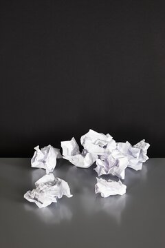 Crumpled paper indoors on a dark background showing failure