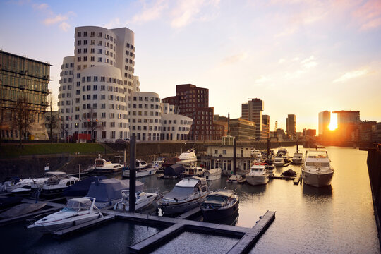Germany, Dusseldorf, media harbor with marina at sunset