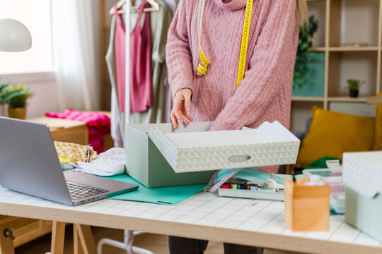 Fashion designer packing order in start up office