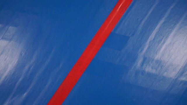 Rotation of striped blue electrical tape surface. Close-up, topview