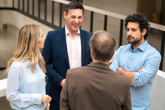 Business colleagues planning strategy together in corridor