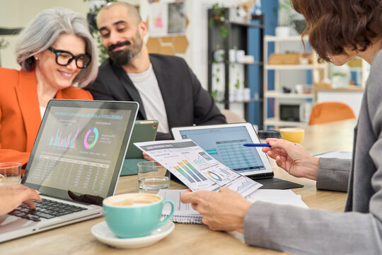 Business colleagues analyzing financial charts during office meeting