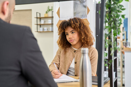 Businesswoman listening during an office coaching meeting