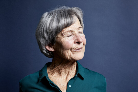 Portrait of smiling senior woman with eyes closed