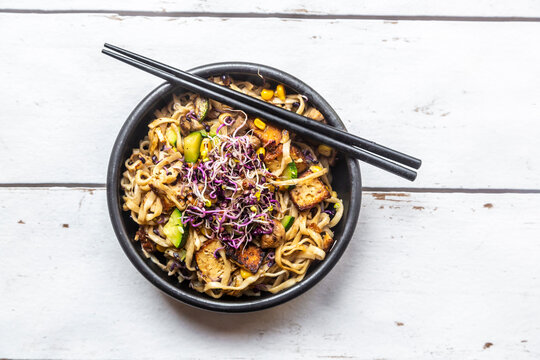 Mie noodles with tofu, zucchini, maize and red sprouts