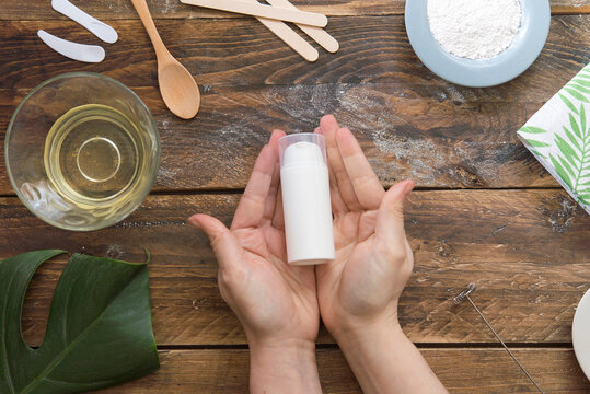 Natural cosmetics, do-it-yourself, hands holding pump bottle