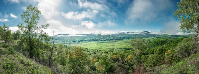 Fototapeta premium Mountains in Adygea. Panoramic view from the observation deck of the valley in the village of Dakhovskaya, Republic of Adygea.