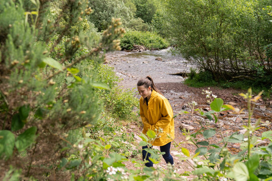 Woman hiking enjoying nature by a flowing river