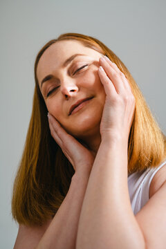 Mature woman touching face, healthy skin and anti aging skincare