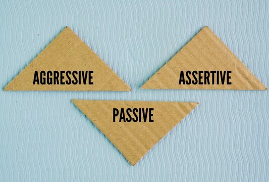 Box paper with the words Passive, Aggressive, and Assertive are three primary communication and behavioral styles. Passive means prioritizing others while ignoring your own needs