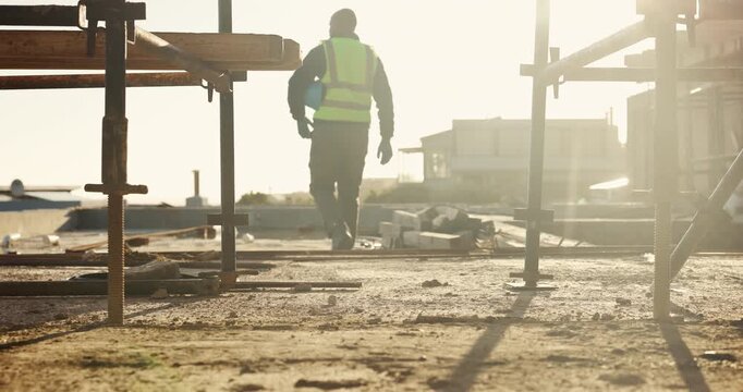 Legs, engineer and walking on rooftop for construction, inspection and planning for architecture. Back, man and thinking with hard hat for quality assurance, building progress and urban development