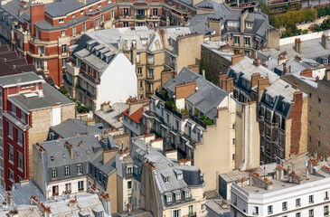 Fototapeta premium Paris rooftops, with chimneys and dense residential buildings
