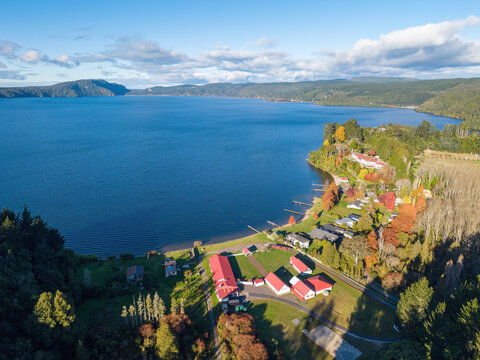 Lake Rotoiti in the Rotorua Lakes district, New Zealand, seen from the air in autumn. On the shore is Tapuaekura Marae