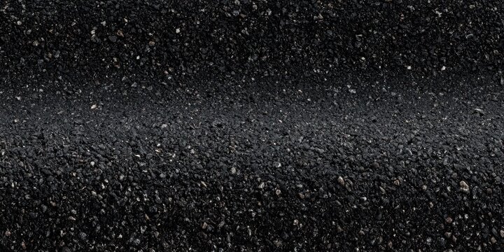 Coarse asphalt aggregate surface closeup on road shoulder
