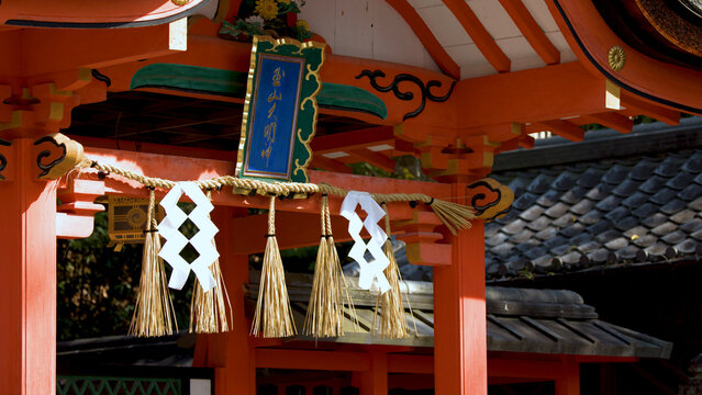 Close-up of Vermilion Shinto Gate with Shimenawa Rope and Shide Streamers