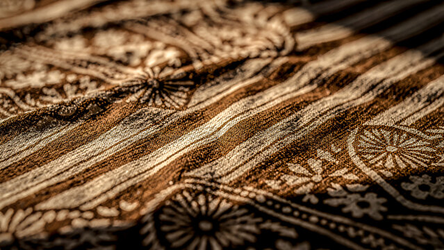 Indonesian batik fabric, traditional machete motif, hand-drawn diagonal blade design, dark brown soga and natural creamy white, visible cotton weave texture, cultural heritage fabric.